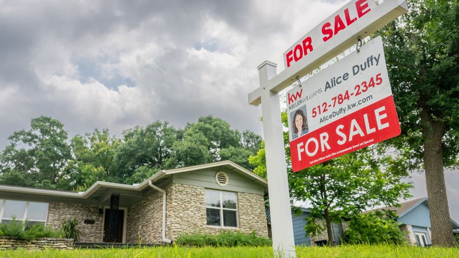 house for sale with clouds overhead