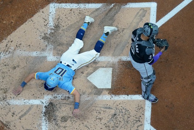 Milwaukee Brewers' Sal Frelick hits a home run against Chicago White Sox's Martín Maldonado in the second inning of a baseball game, Friday, May 31, 2024, in Milwaukee.  (AP Photo/Morry Gash)