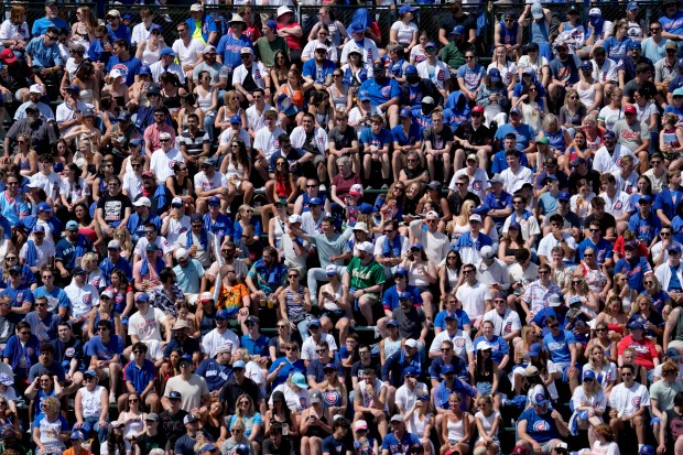 Baseball fans watch during the sixth inning of a baseball game between the Cincinnati Reds and the Chicago Cubs in Chicago, Sunday, June 2, 2024. (AP Photo/Nam Y. Huh)