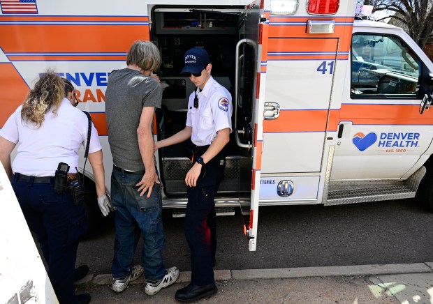 Denver Health paramedic trainer Keri Reiner, left, and paramedic Aiden Beatty, right, help a dog bite victim in north Denver on April 3, 2024. (Photo by Andy Cross/The Denver Post)