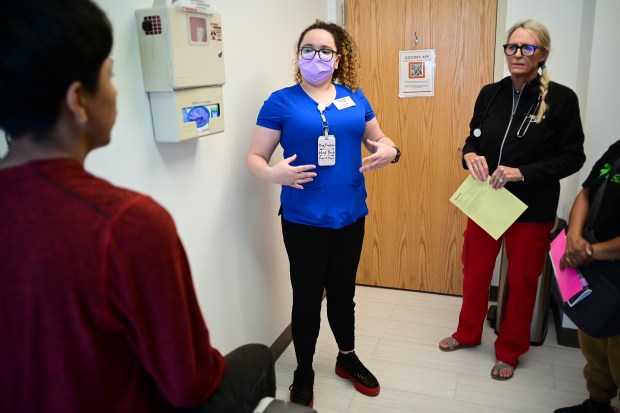Student nurse Helda McCauley, center, translates for registered nurse Sue Covington, right, to communicate with a patient at the Doctors Care clinic in Littleton, Thursday, May 30, 2024. (Photo by Hyoung Chang/The Denver Post)