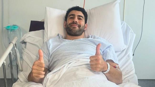 Petracca thumbs up from her hospital bed after surgery.