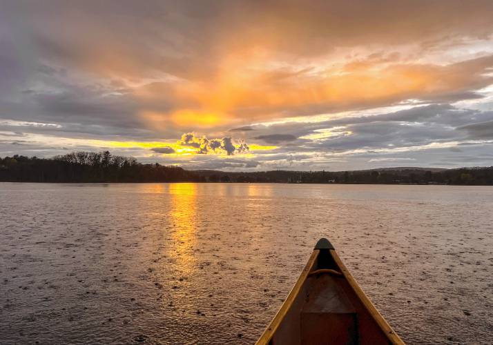 A light rain falls as the sun sets over Barton Cove in Gill.