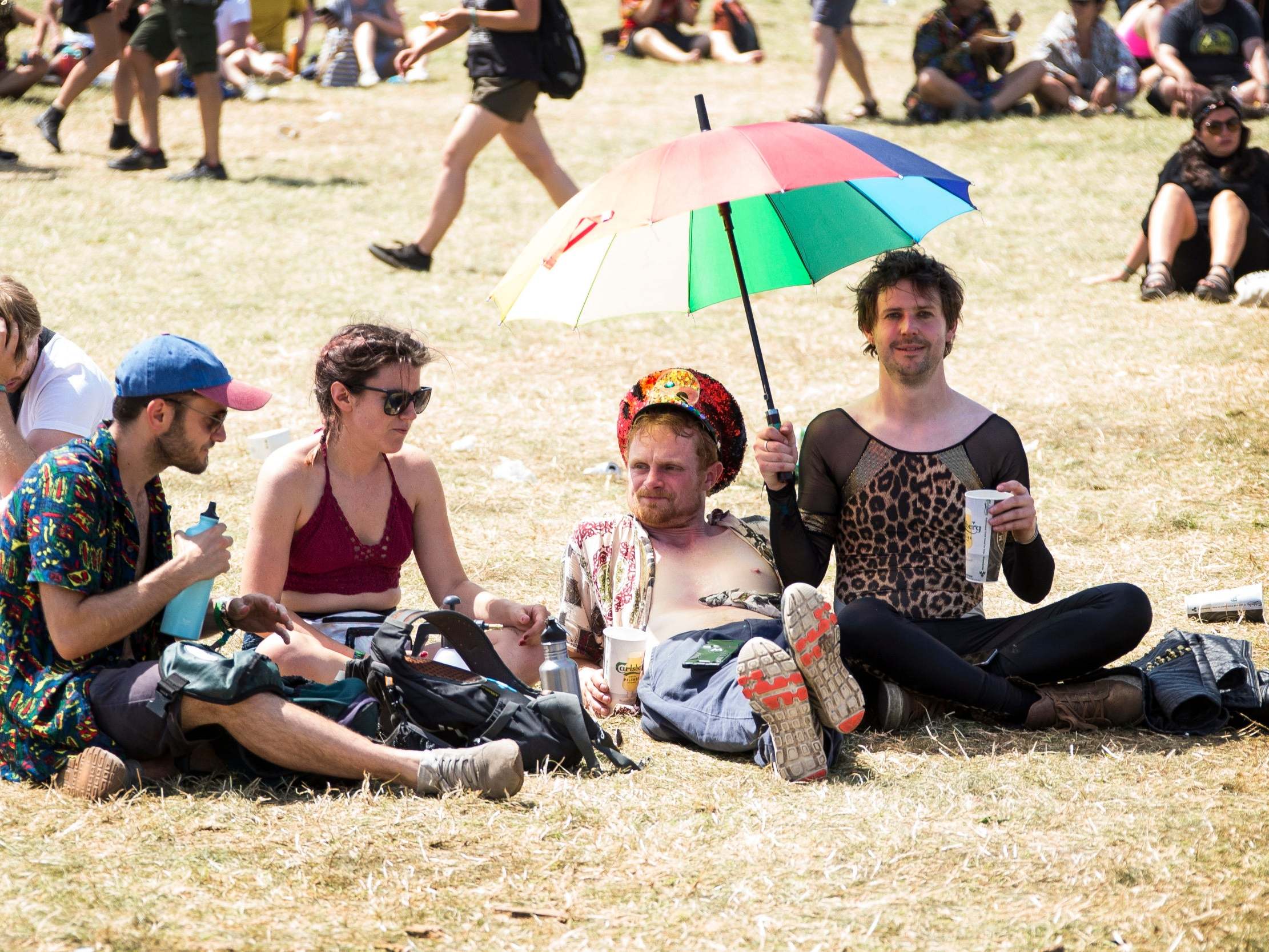 Festival goers take shelter from the sun on day four of Glastonbury Festival