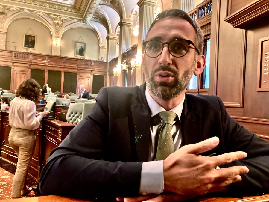 FILE - Illinois State Rep. Will Guzzardi, Dist.  Chicago, speaks to a reporter on the floor of the Illinois House in Springfield, Illinois, May 11, 2023. The Illinois General Assembly is poised to right a 175-year-old wrong by returning land in northern Illinois guaranteed to a Potawatomi chief in 1829. (AP Photo/John O'Connor, file)